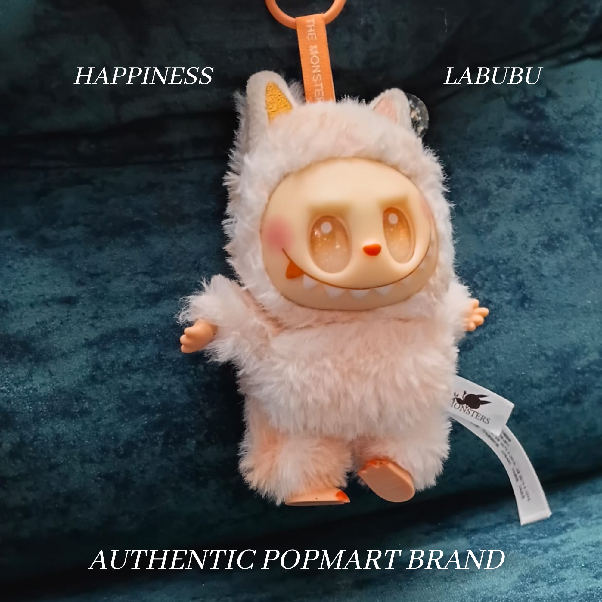 Plush toy with a tag on a blue background, featuring the brand 'Happiness Labubu'.