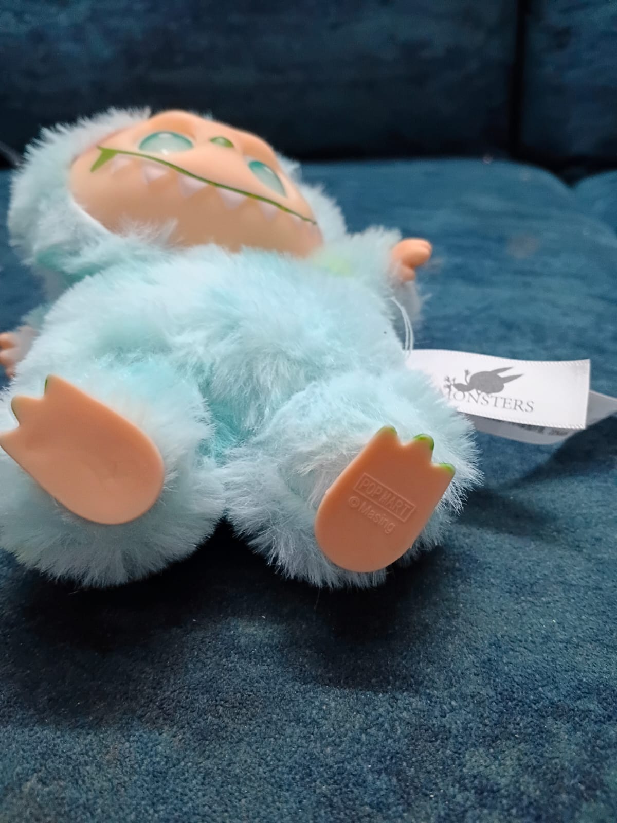 Plush toy with a tag on a blue surface