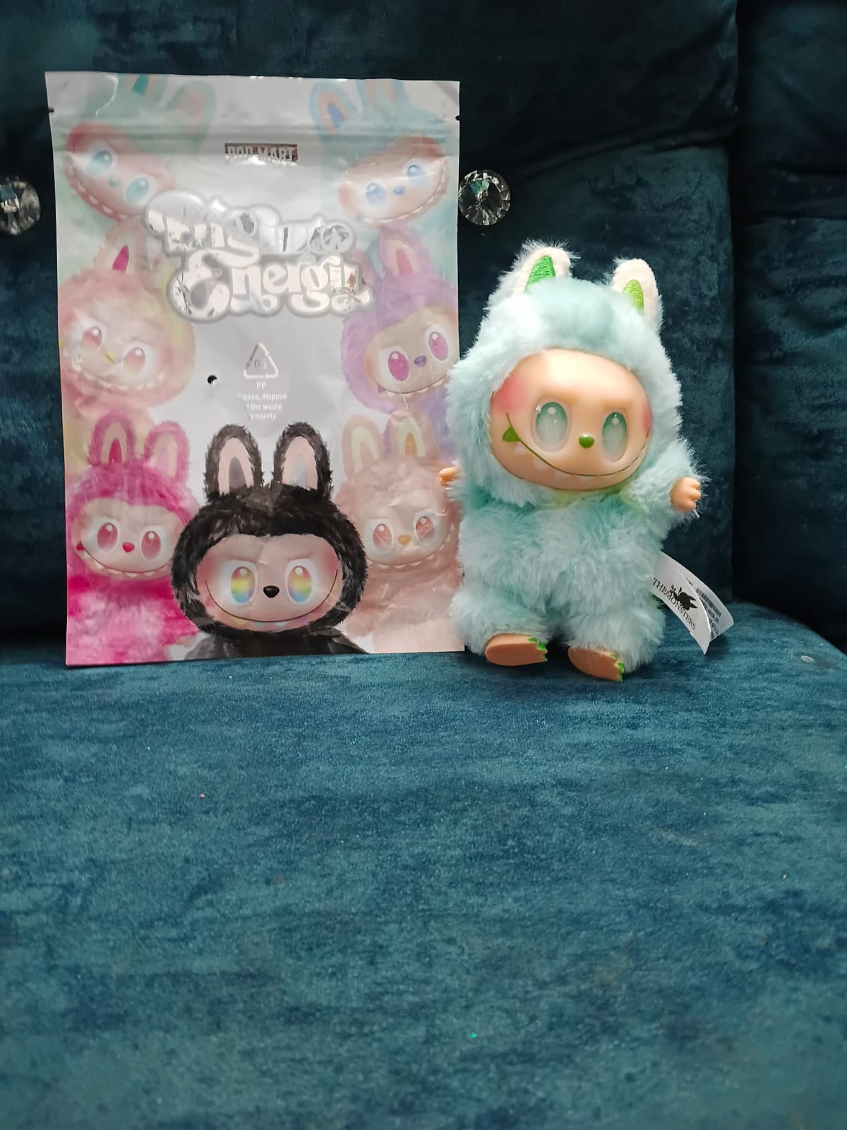 Plush toy with packaging on a blue surface