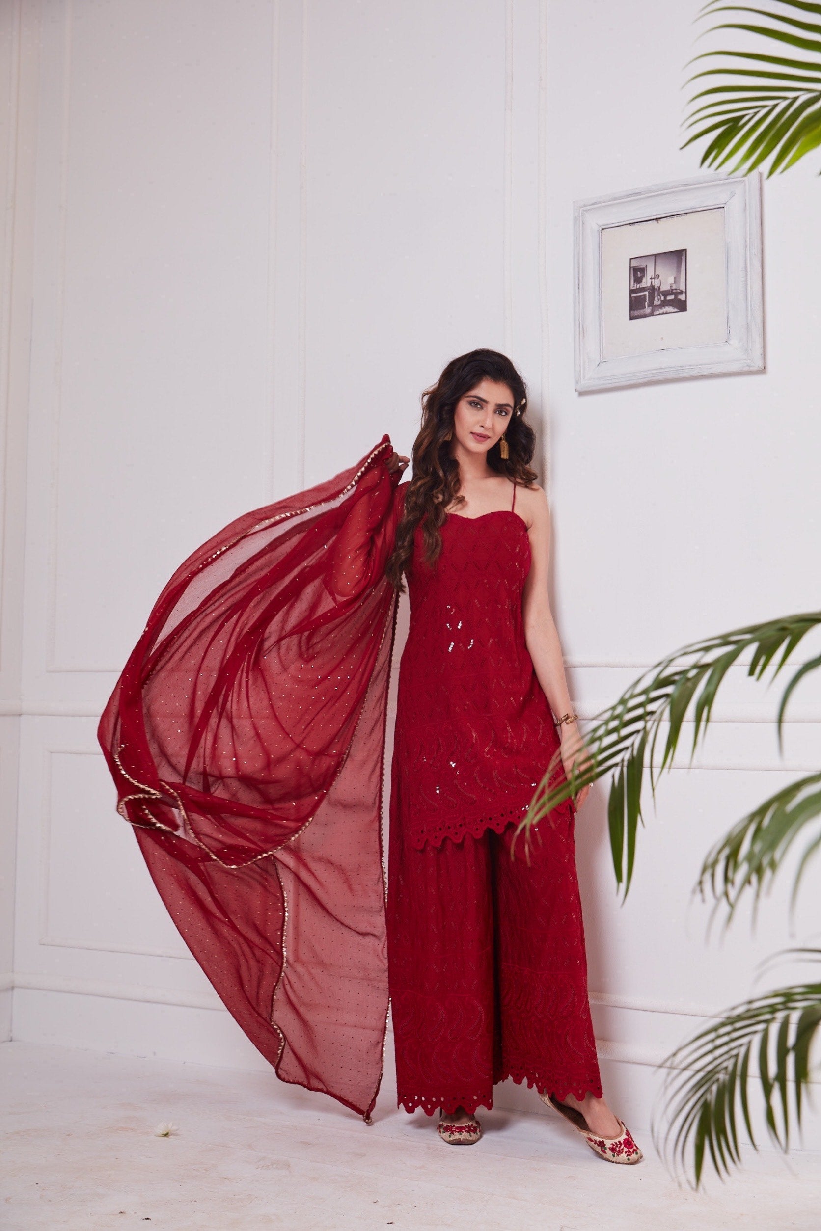 Nikita Sharma's rayon schiffly sequin work embellished Maroon Gharara set & Dupatta