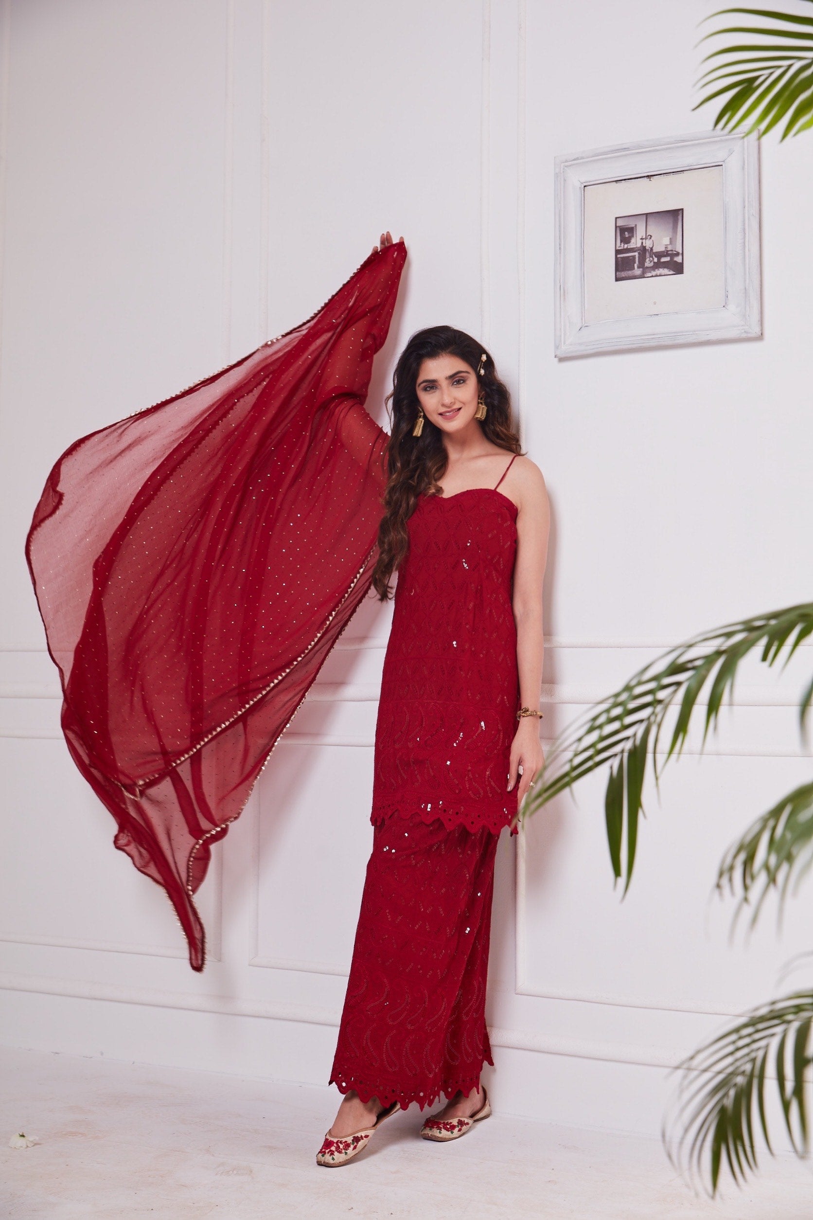 Nikita Sharma's rayon schiffly sequin work embellished Maroon Gharara set & Dupatta